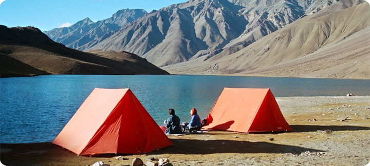 Camping tents beside Chandratal Lake at sunset