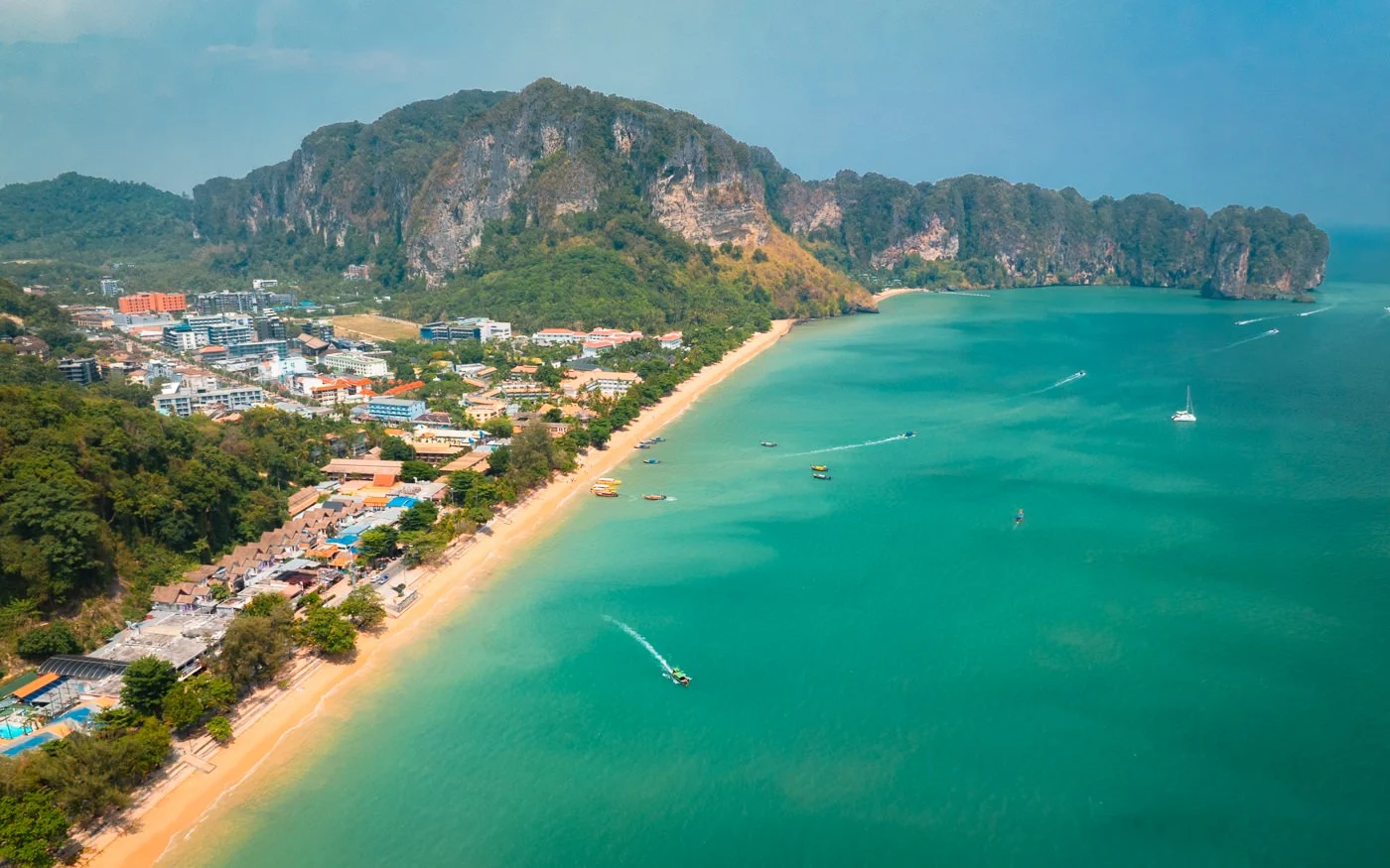 Ao Nang Beach with longtail boats and limestone cliffs