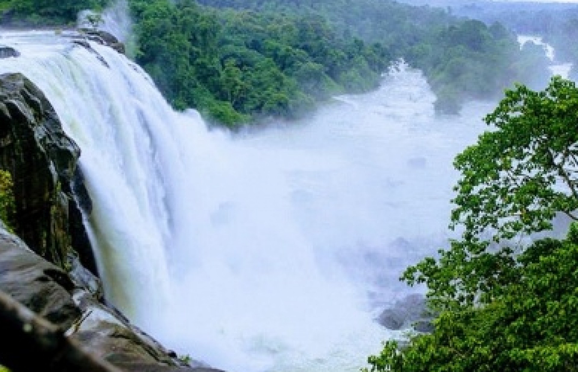 Athirappilly Waterfalls during peak monsoon season with heavy flow