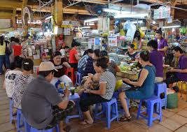 Food stalls and seating area inside Ben Thanh Market