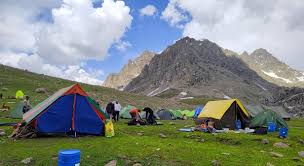 Camping tents near Gangabal Lake with Mount Harmukh reflection