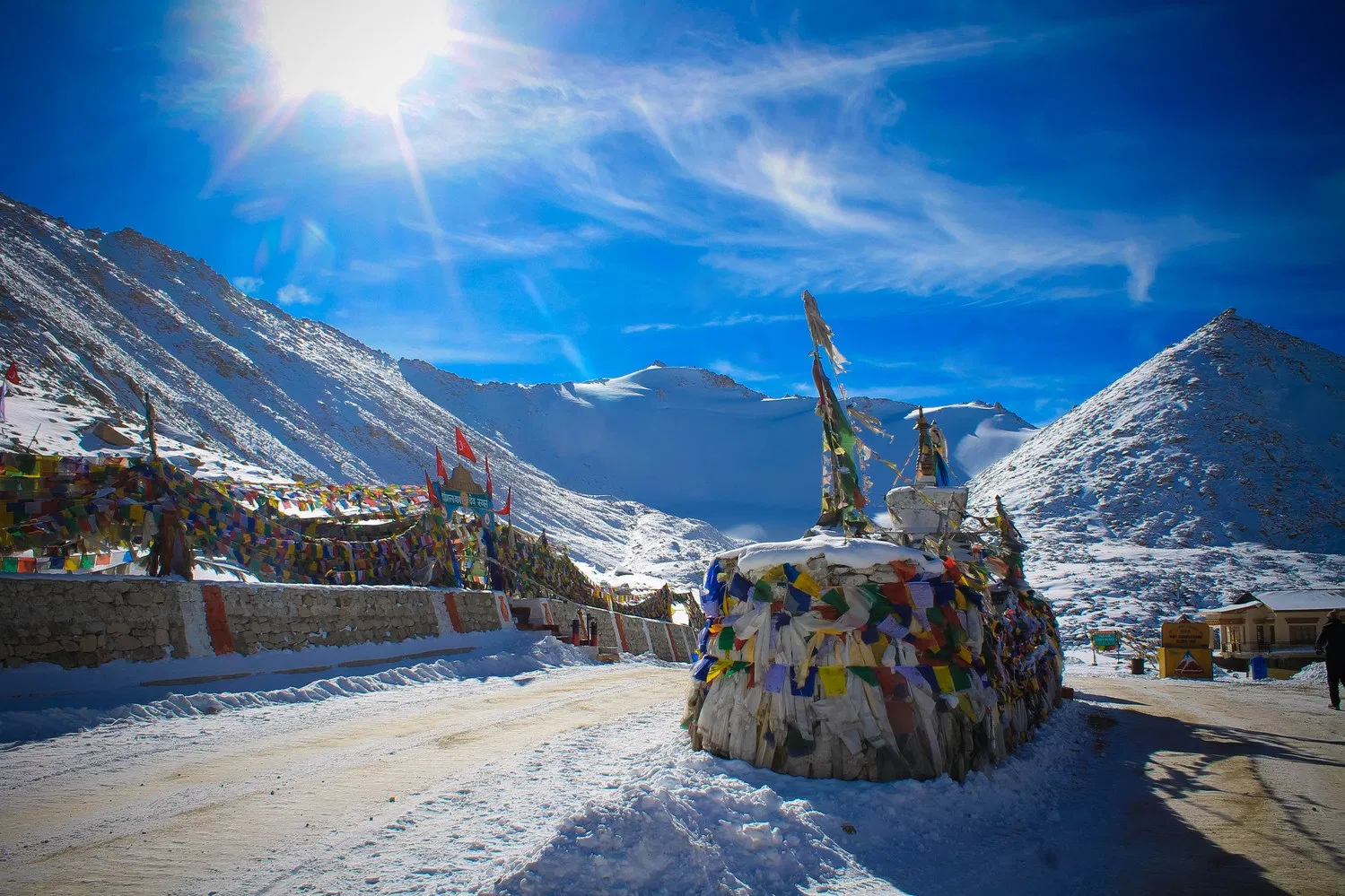 Khardung La Pass signboard with vehicle