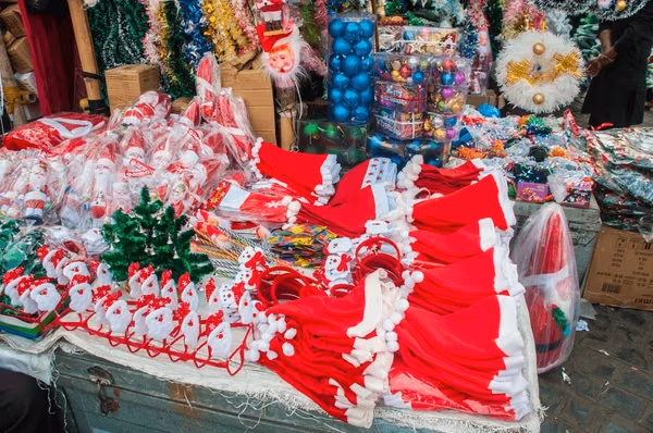 Crowded Christmas shopping stalls with gifts and decorations