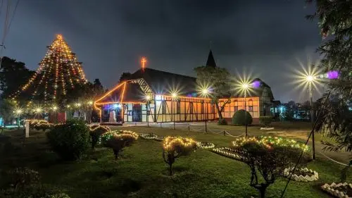 Evening church lights and congregation flow in Shillong
