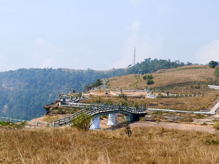 Scenic road route leading to Eco Park through lush green hills