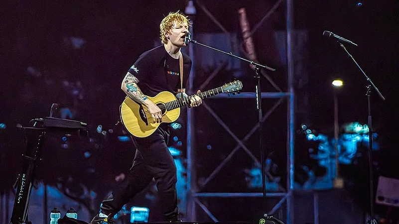 Ed Sheeran live concert crowd in India with stage lights and packed audience