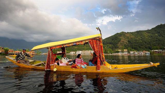 Shikara passing through floating gardens Dal Lake