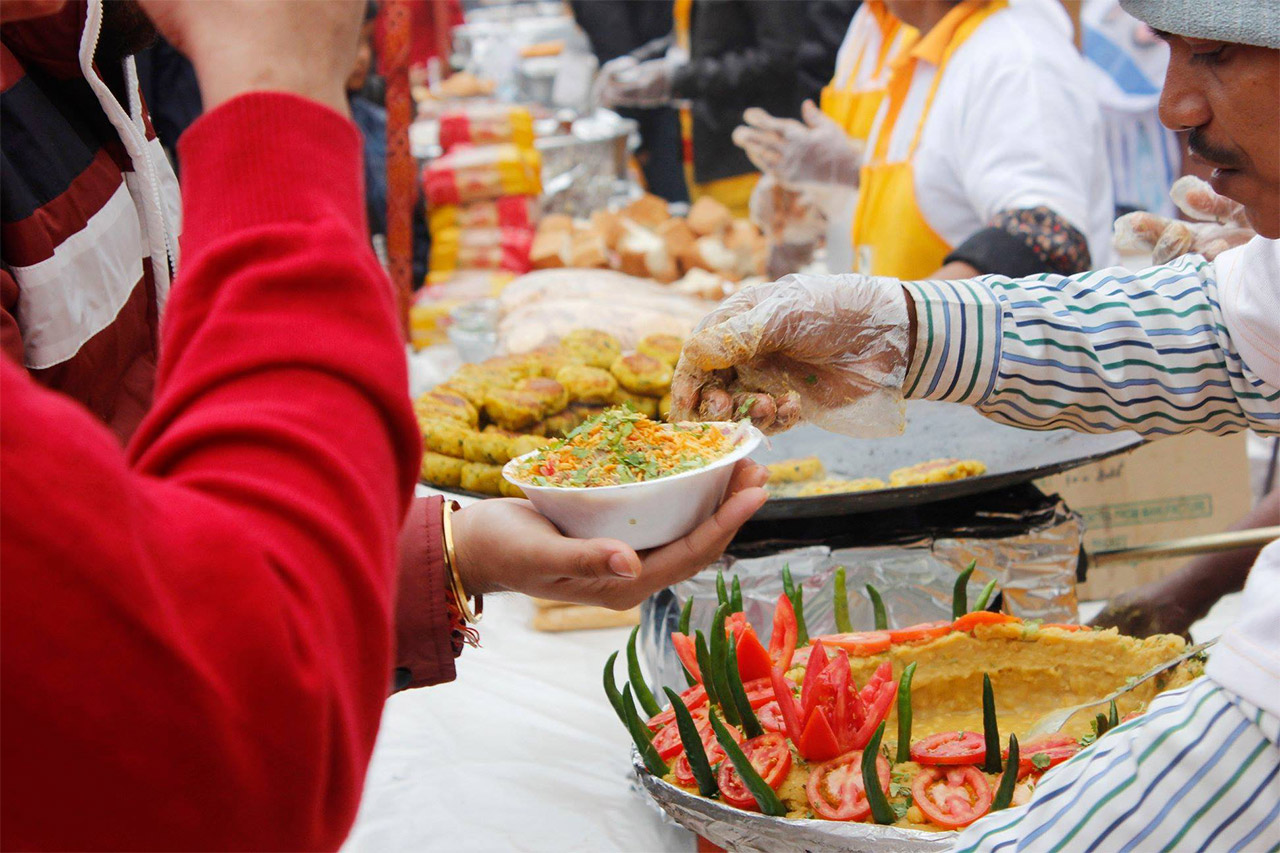 Festival visitors choosing food stalls with hygiene and queue indicators