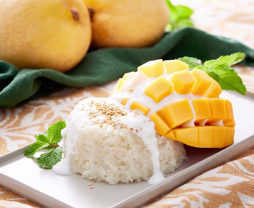 Traditional Thai mango sticky rice dessert with coconut cream
