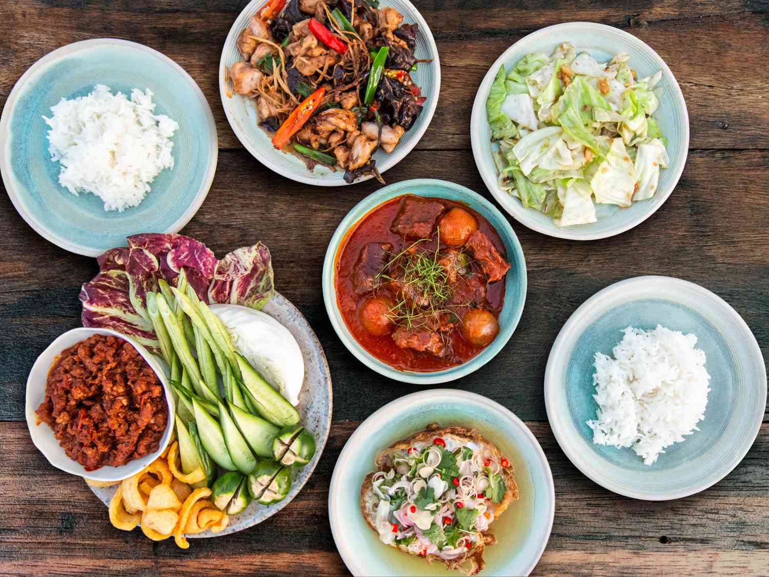 Spread of authentic Thai dishes including curries, noodles, and street food