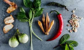 Fresh Thai ingredients including lemongrass, chilies, lime, and galangal