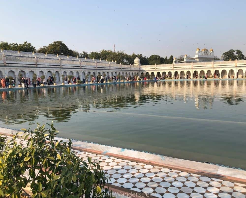 Sacred Sarovar pond at Gurudwara Bangla Sahib with golden dome reflection