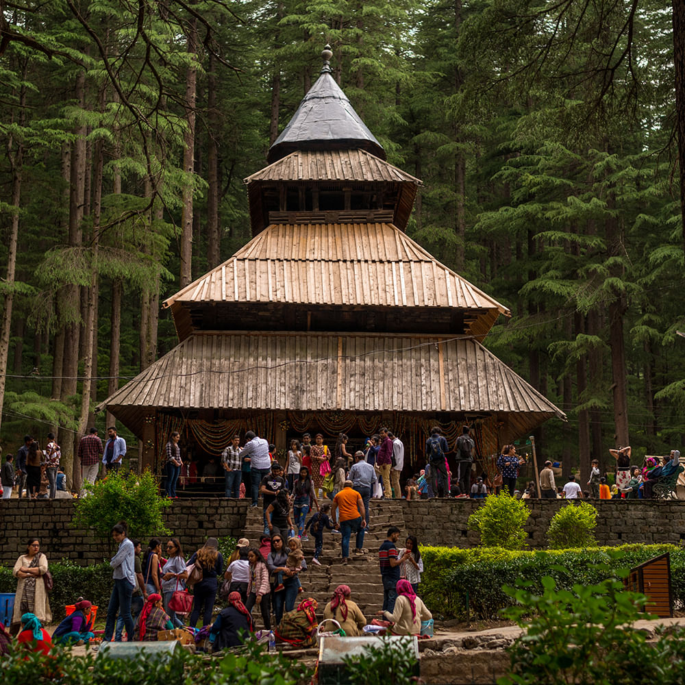 Temple courtyard and prayer activity at Hidimba Devi Temple