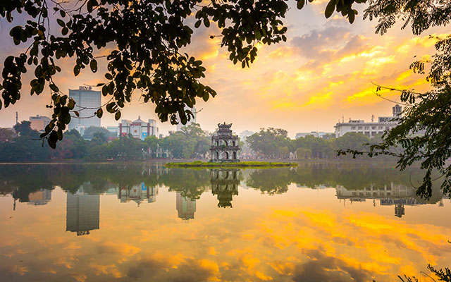 Morning scene at Hoan Kiem Lake with calm water