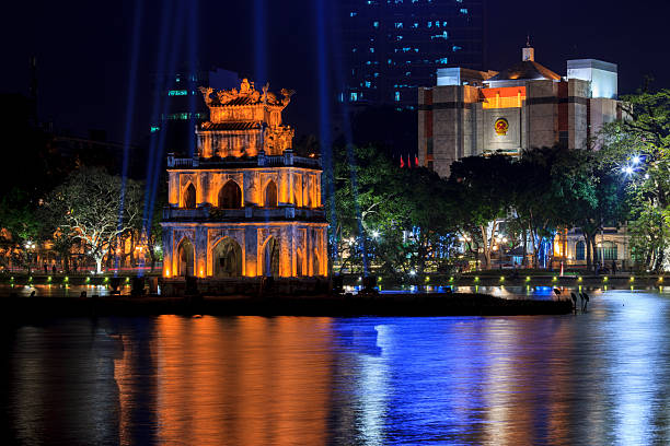 Turtle Tower illuminated at night in Hanoi