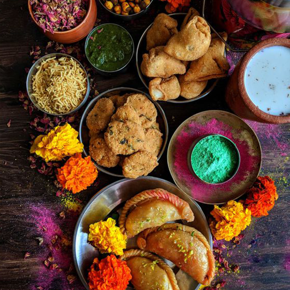 Traditional Holi sweets including gujiya and thandai