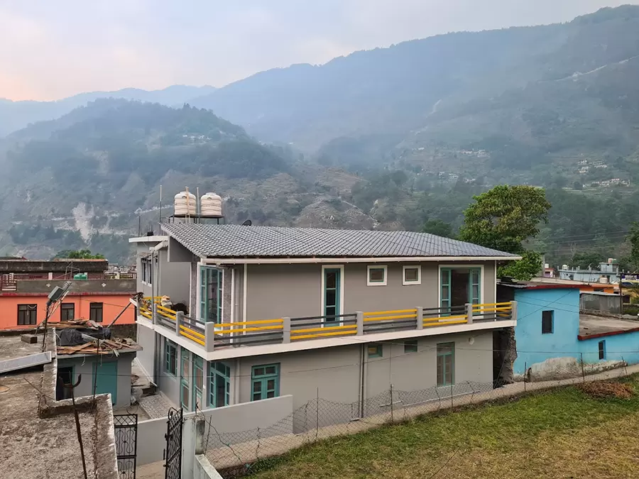 Scenic view of Munsiyari homestay with snow-capped mountains