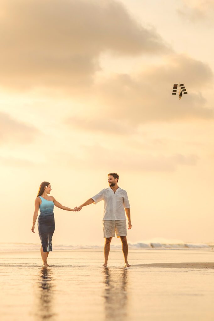 Honeymoon couple walking on Bali beach at sunset