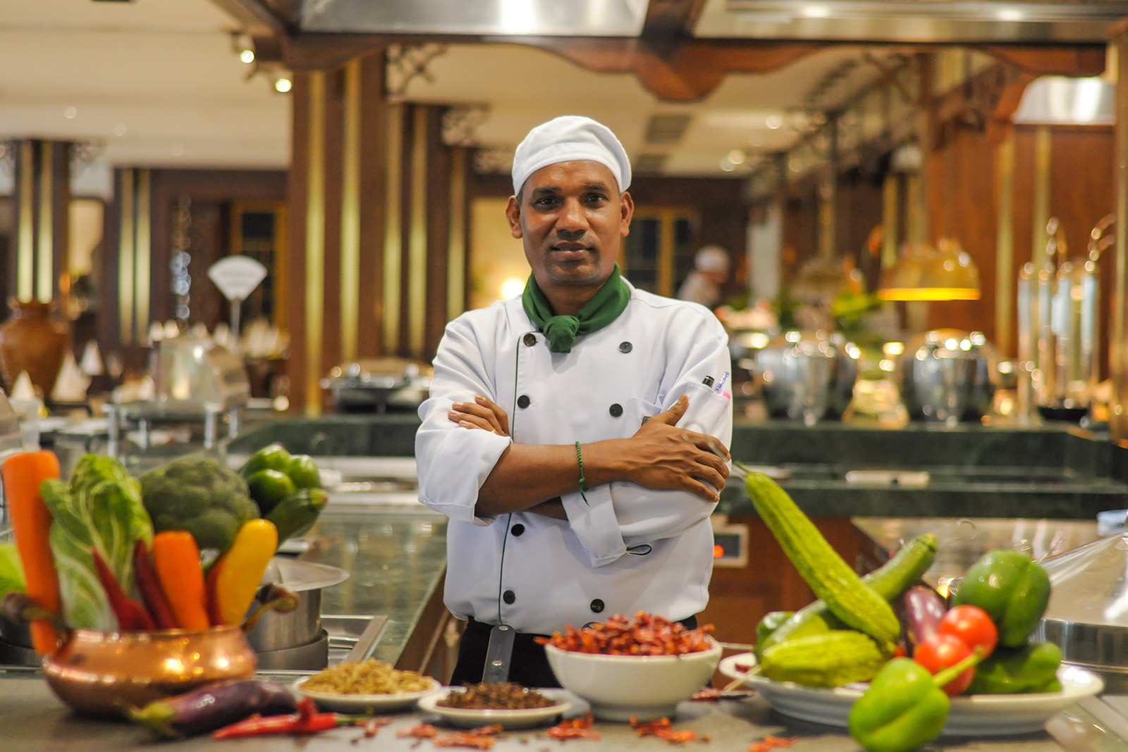 Indian chef preparing curry in Vietnam kitchen