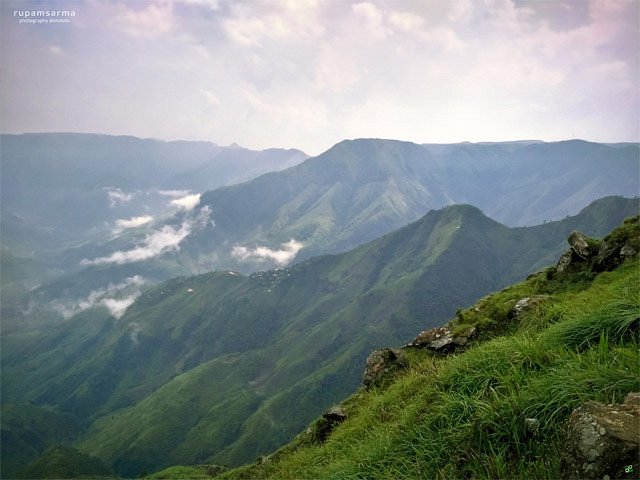 Trekker descending grassy slopes of Laitlum Canyon