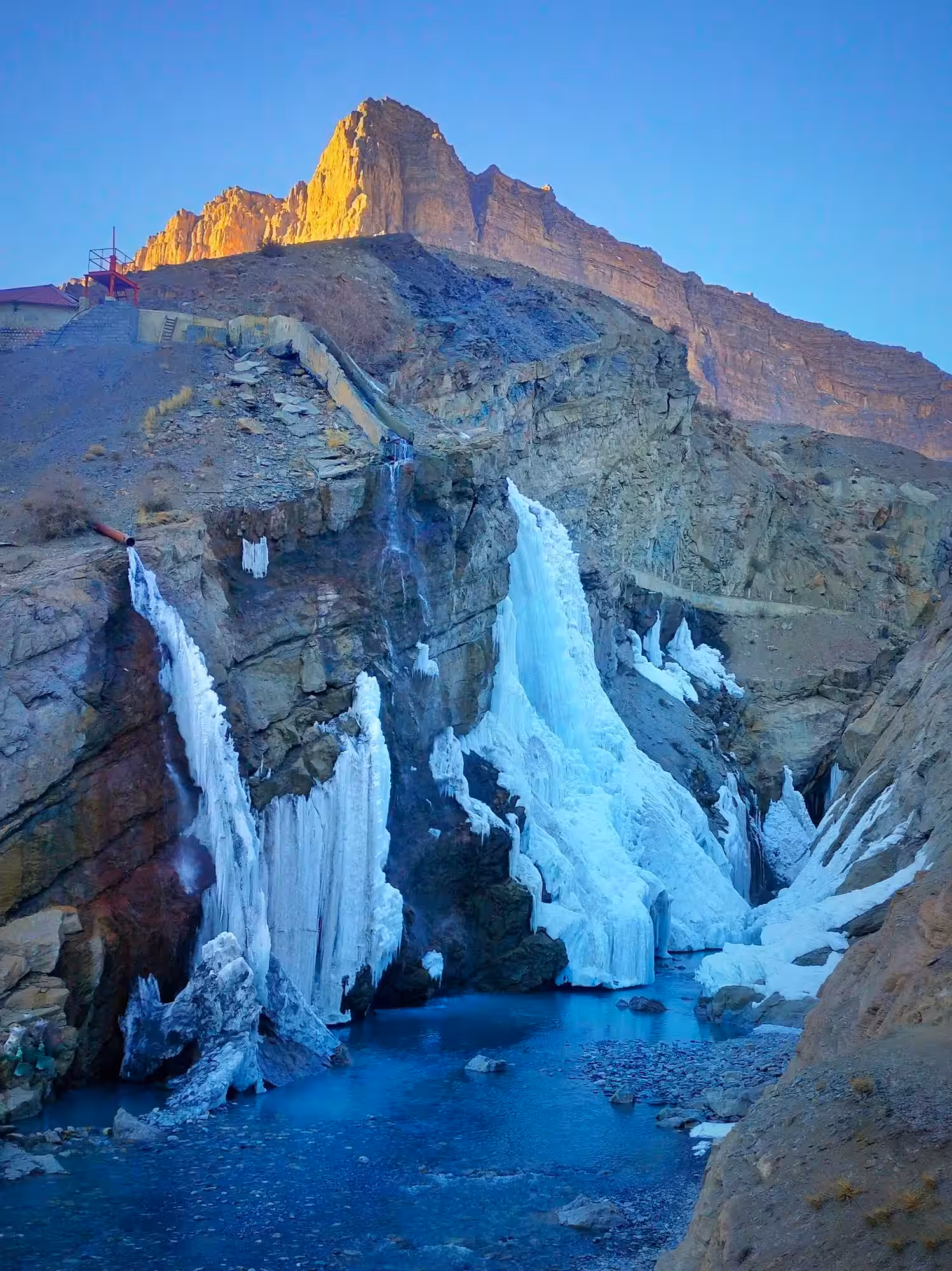 Photographer capturing Lingti Waterfall with professional camera equipment