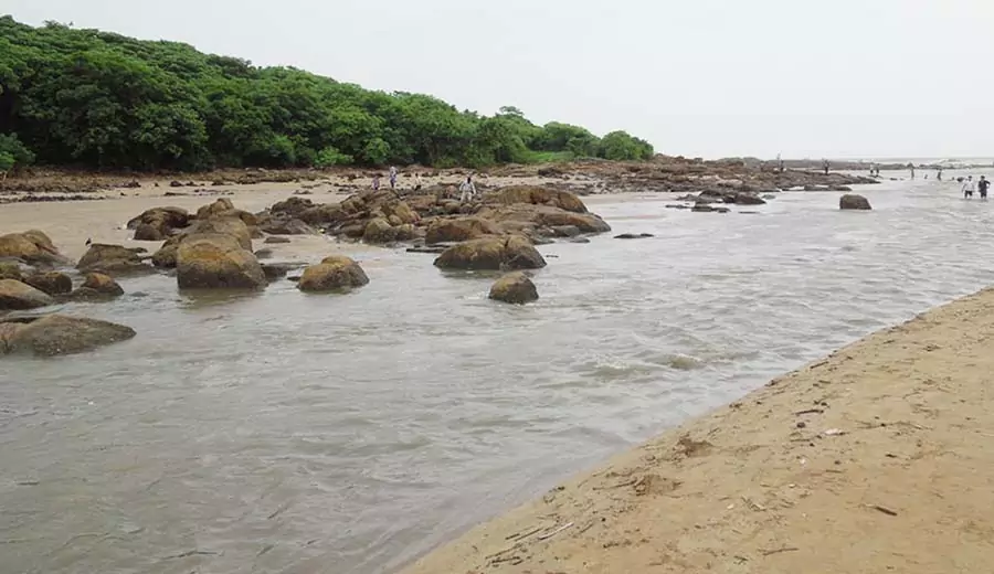 Aksa Beach shoreline with people enjoying and clear blue sky