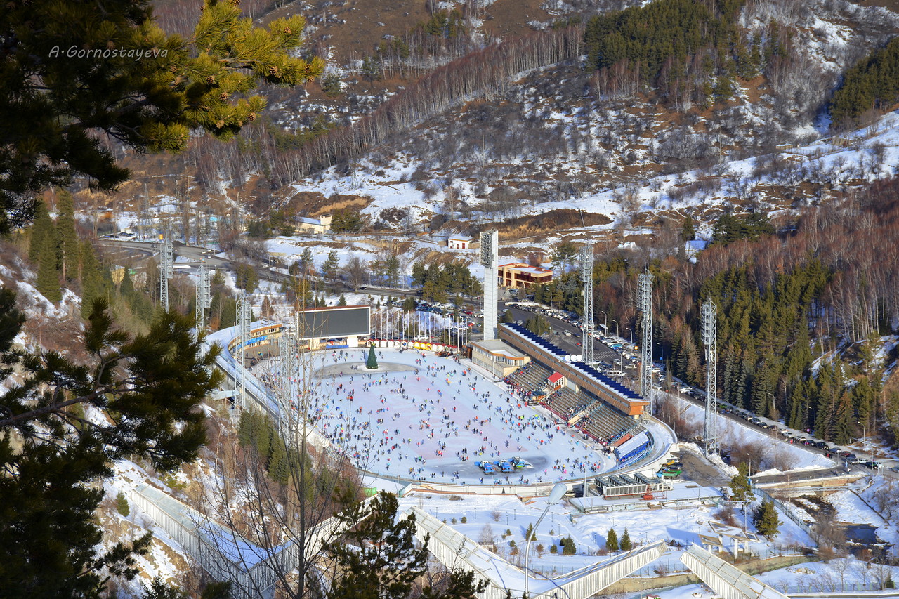 Medeu Skating Rink Almaty set against stunning mountain backdrop with skaters on ice