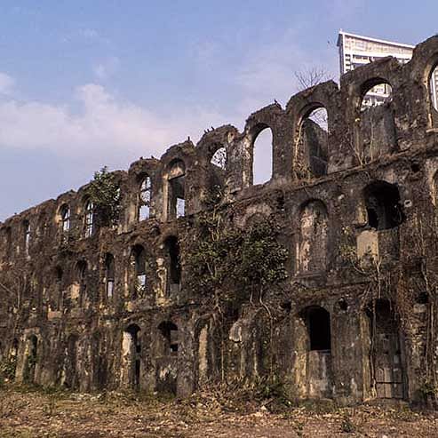 Photographer documenting industrial decay around Mukesh Mills perimeter