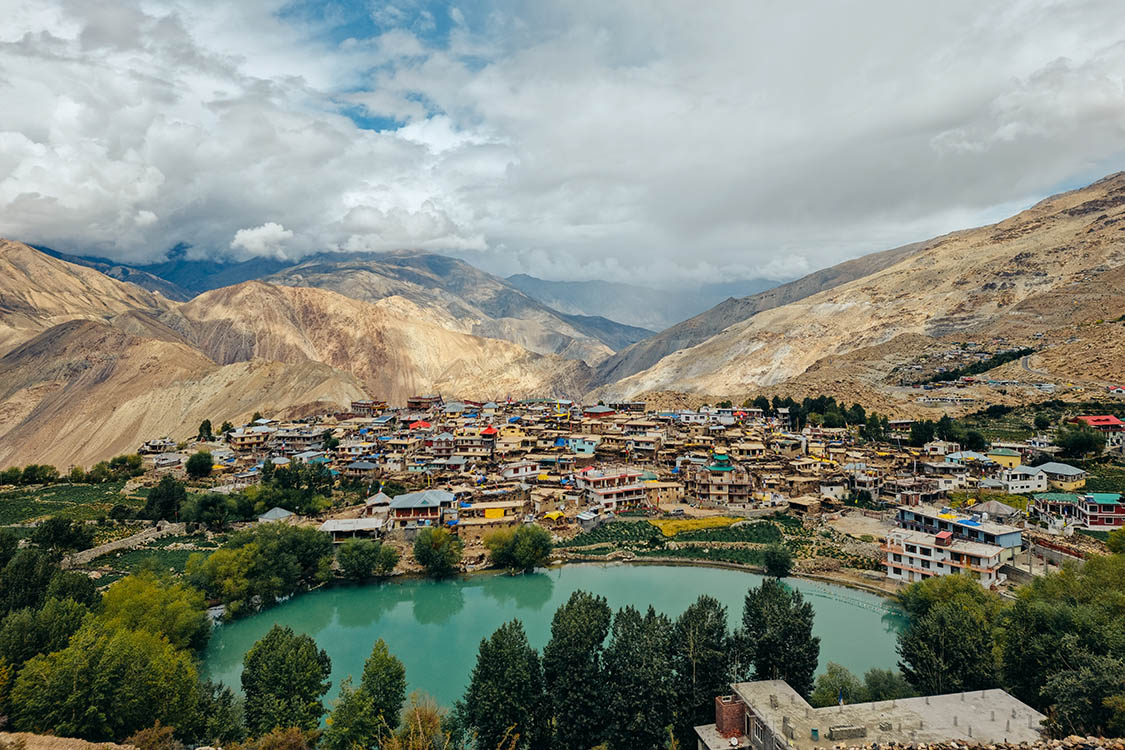 Nako Lake in Spiti Valley with crystal clear waters reflecting snow-capped mountains