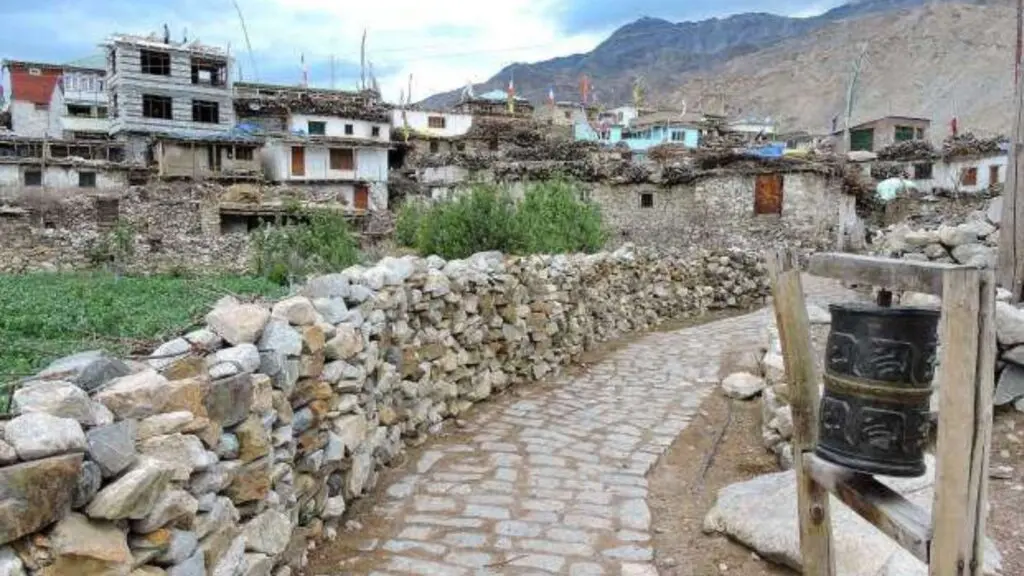 Traditional narrow lanes of Nako village with stone houses and prayer flags