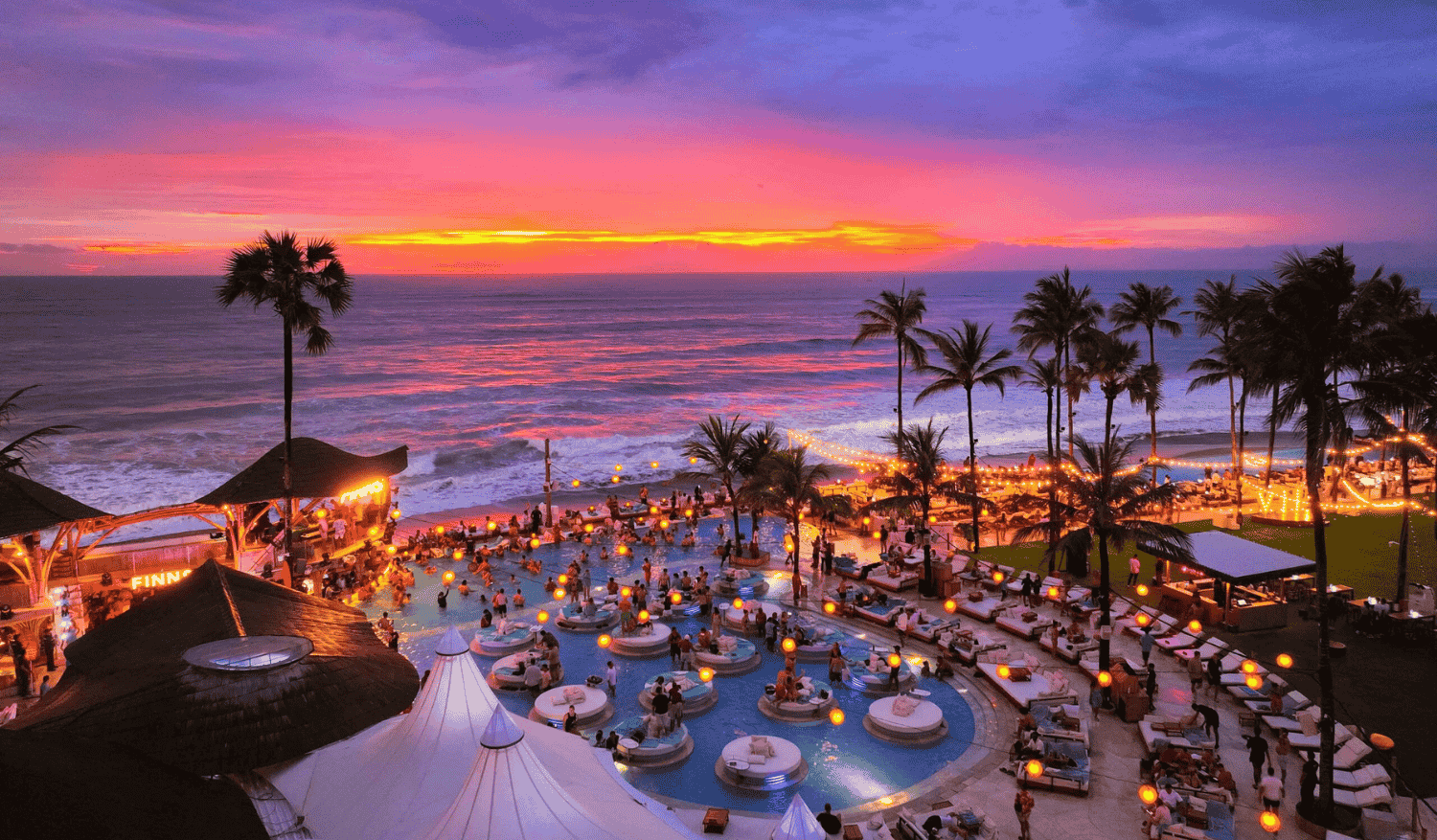Bali beach club nightlife with pool and sunset lights