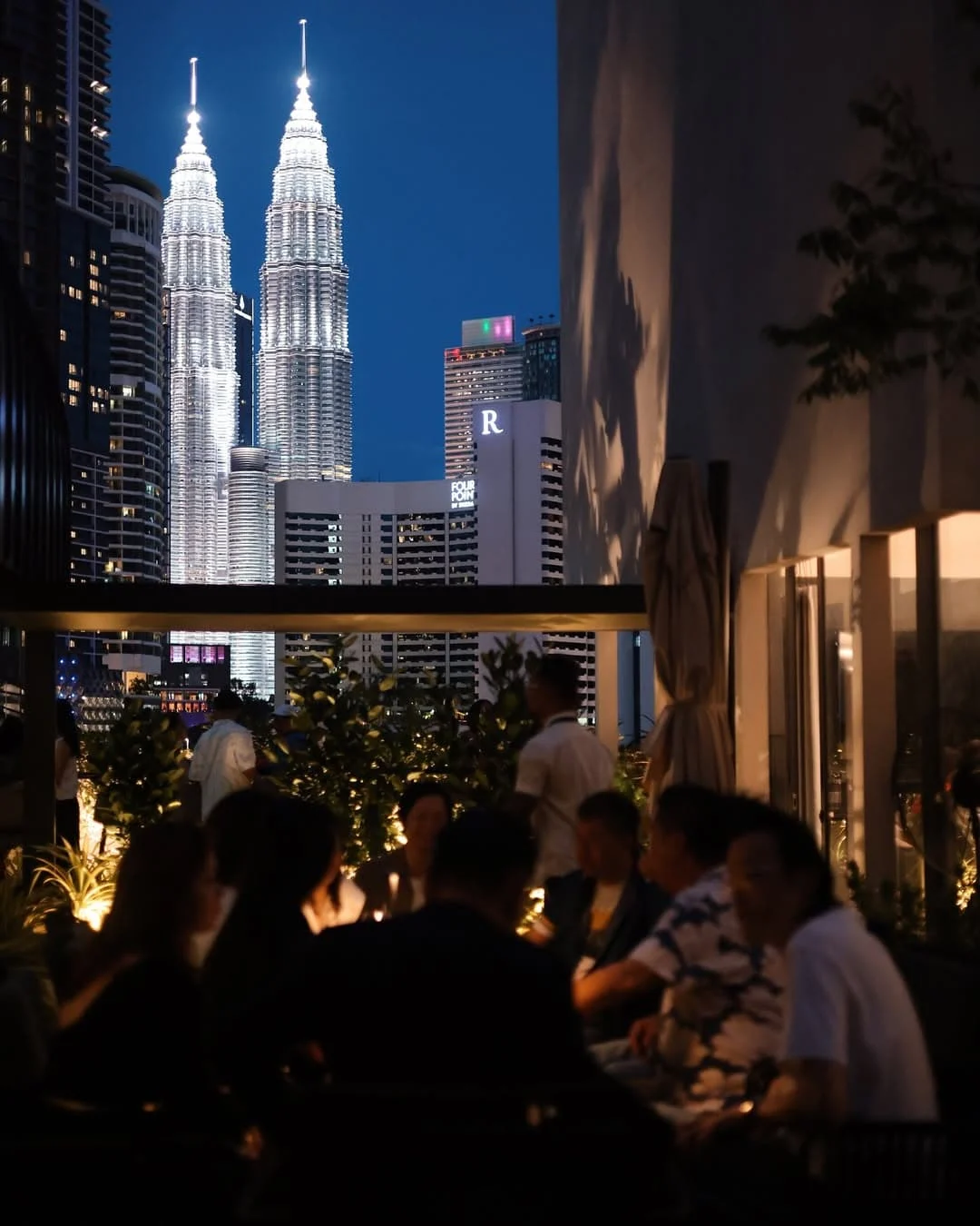 Couple enjoying rooftop nightlife view in Kuala Lumpur