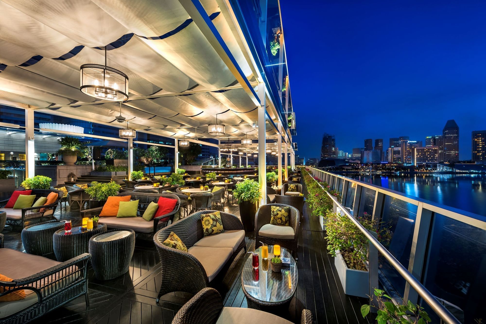 Rooftop bar with Singapore city skyline at night