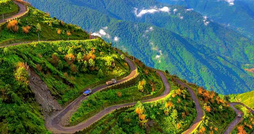 Scenic mountain road in Sikkim with Himalayan peaks in background