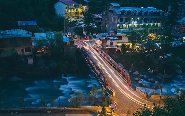Riverside evening atmosphere in Old Manali with cafes and lights