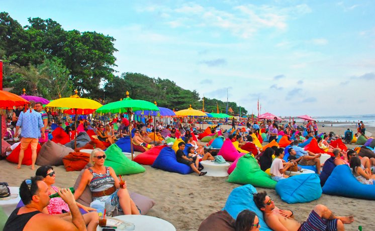 Families and groups enjoying Petitenget Beach Bali