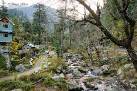 Scenic view of Jibhi valley with traditional houses and mountains