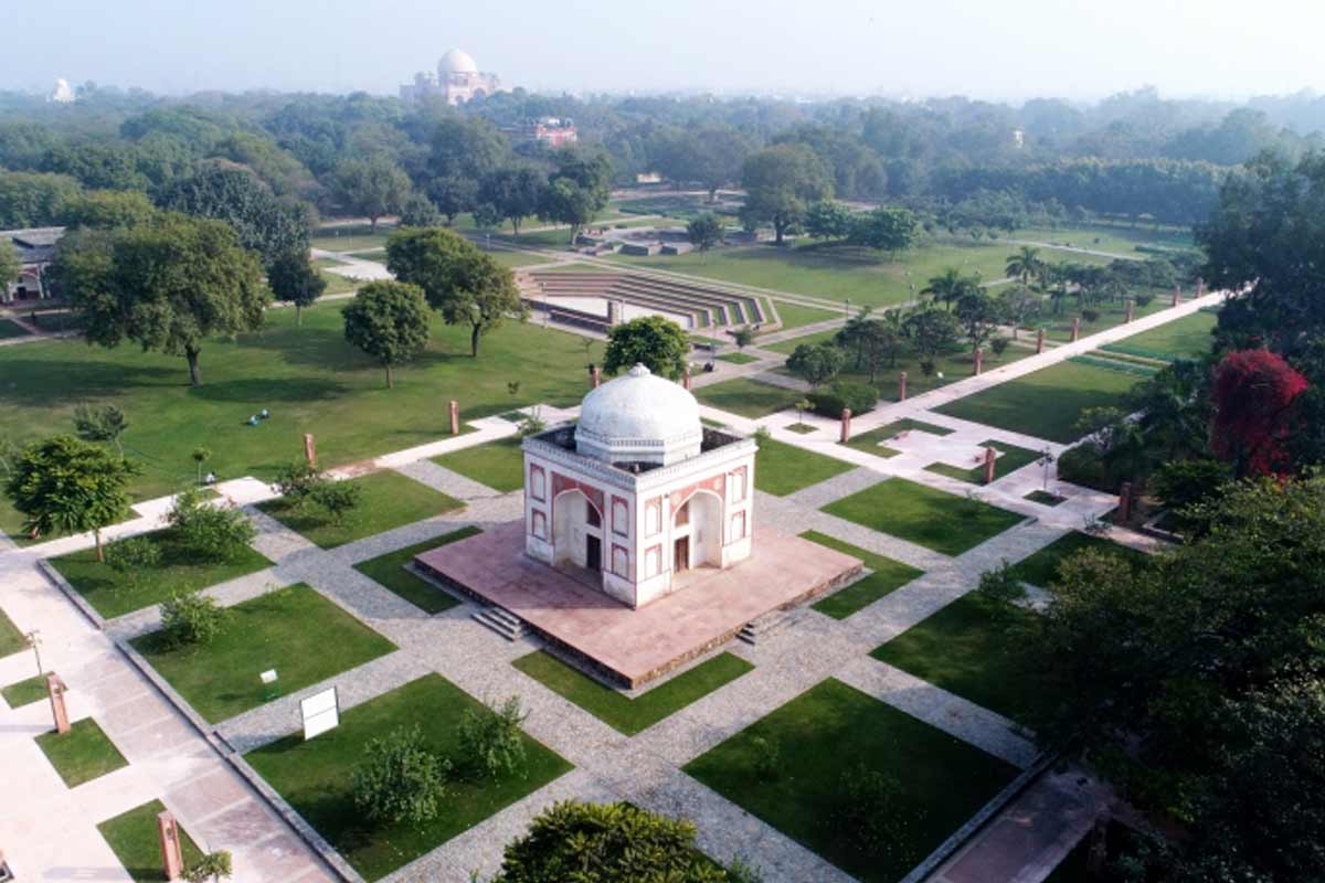 Lush green lawns and historical monuments in Lodhi Garden Delhi during family picnic