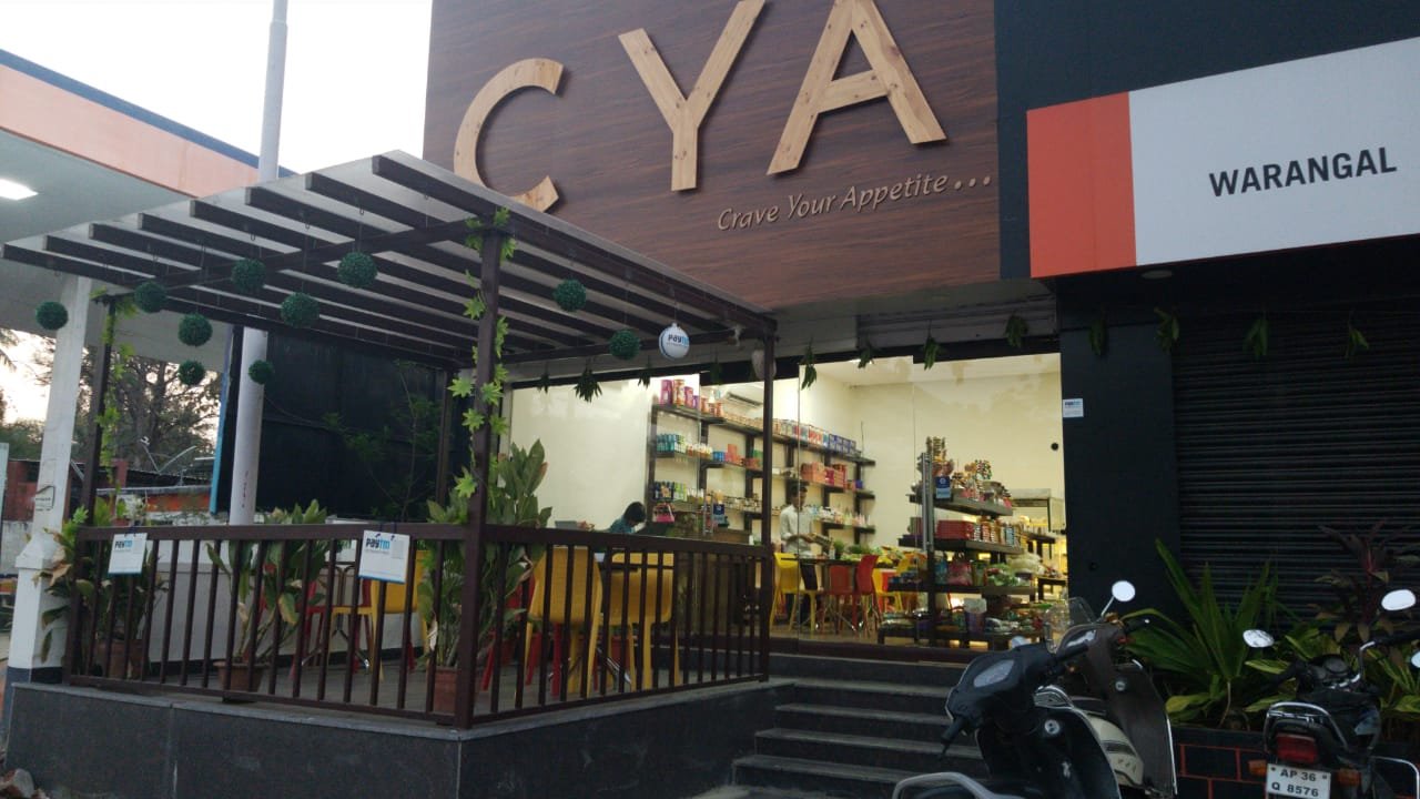 Busy family restaurants and local food tables in Warangal