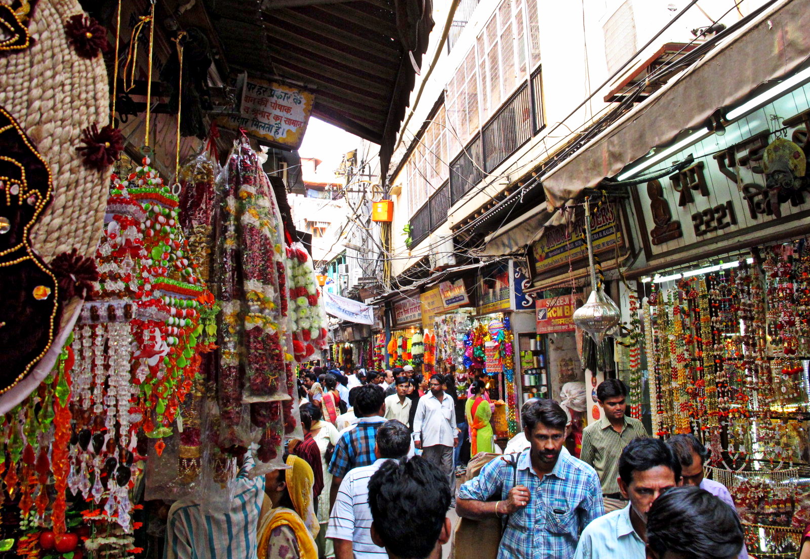 Busy shopping lane in Old Delhi with shops on both sides