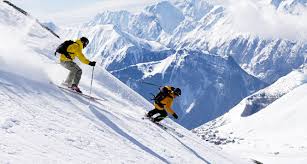 Skiers practicing on Auli ski slopes in winter