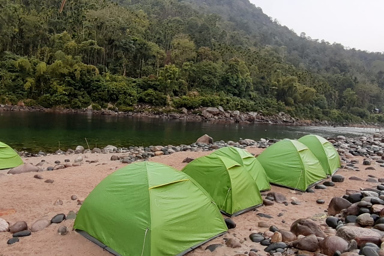 Riverside camping setup and activity zone in Shnongpdeng near Dawki
