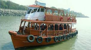 Ferry boat on Mumbai harbor with city skyline in background