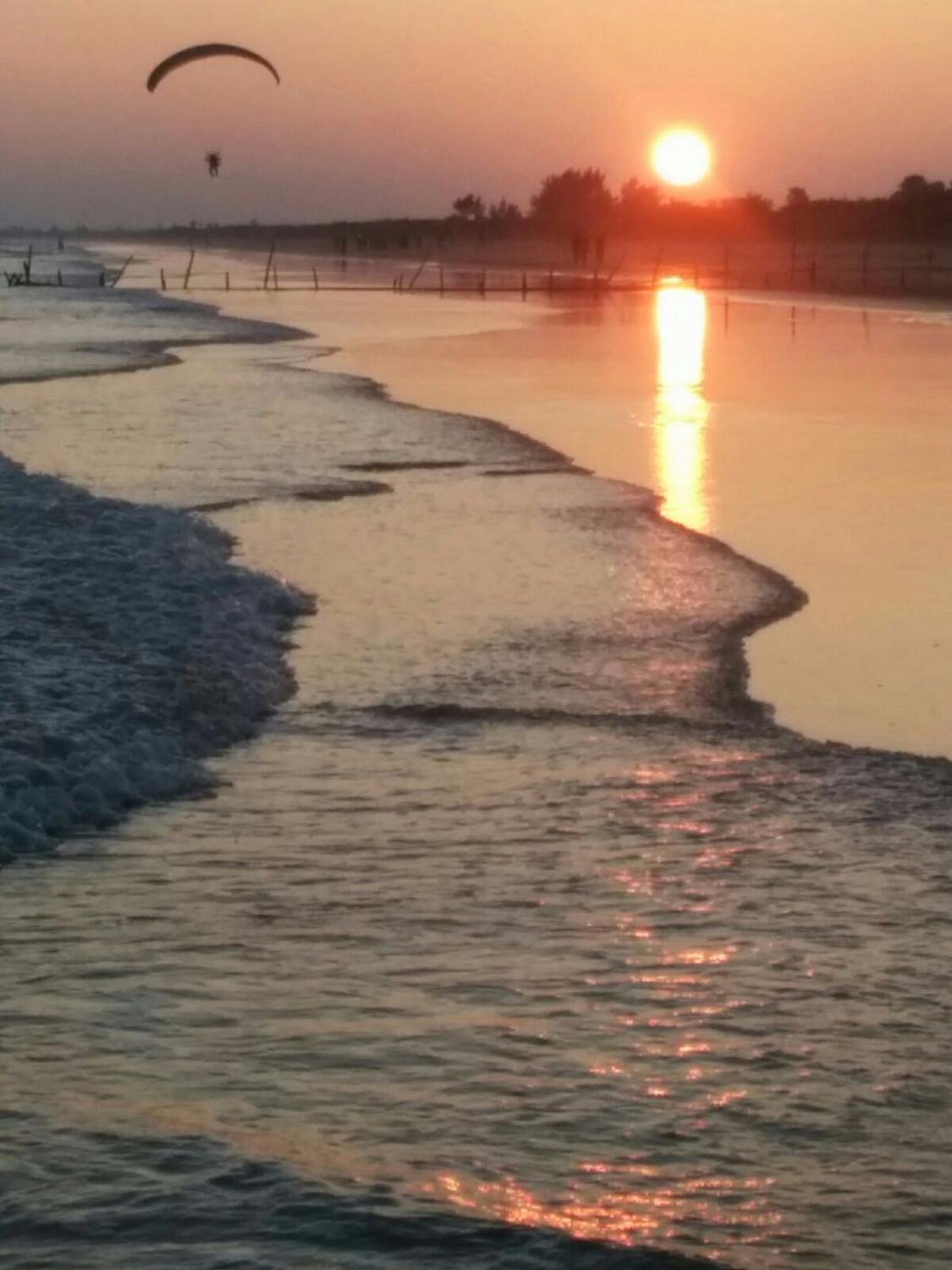 Golden sand and shoreline at Suryalanka Beach near Guntur