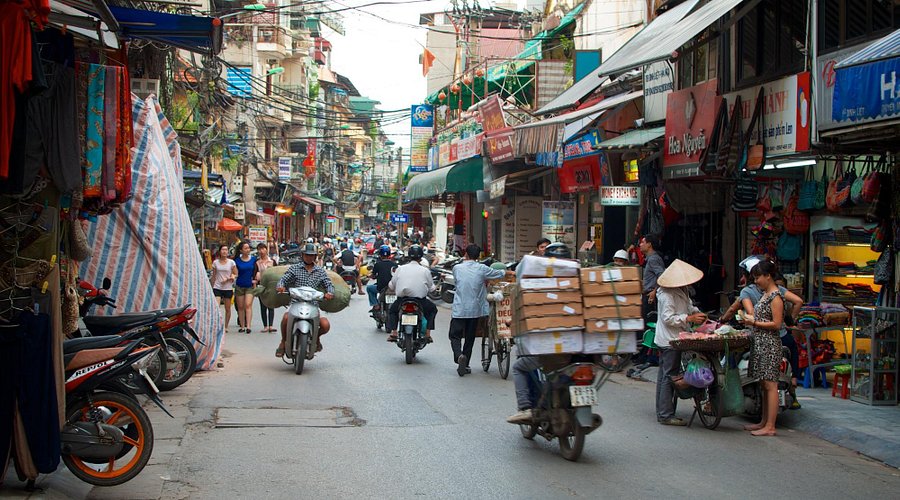Busy old quarter streets in Hanoi with food stalls and shops