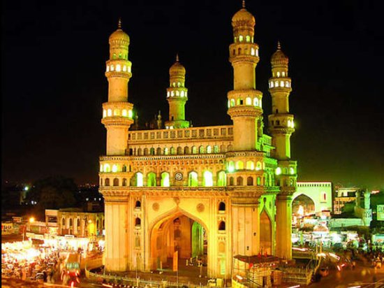 Charminar illuminated at night with bazaar streets in Hyderabad