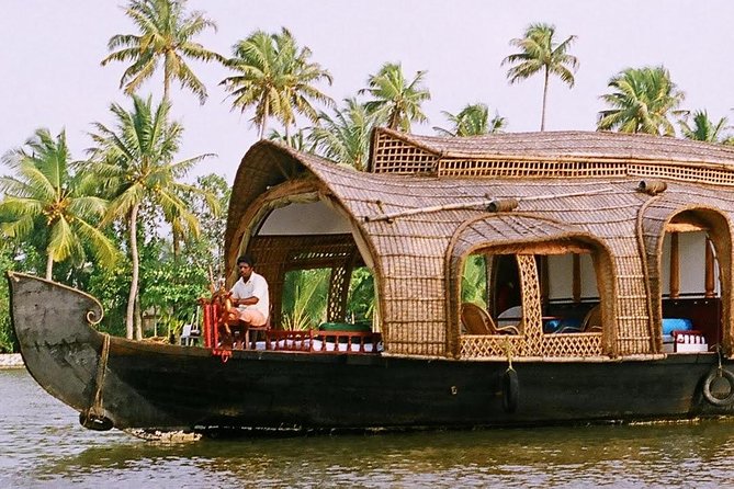 Kerala backwaters with traditional houseboat and coconut trees