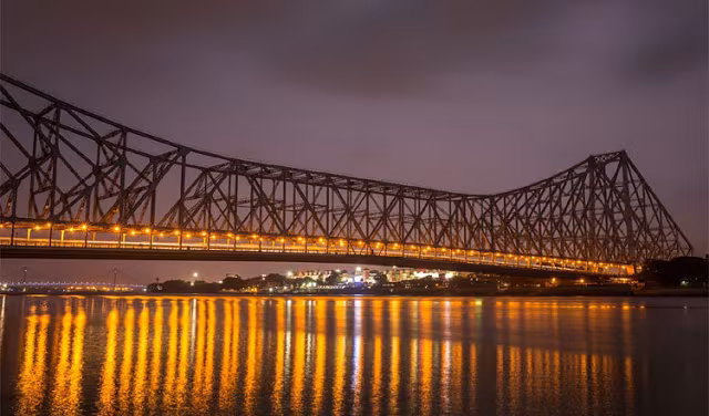 Howrah Bridge evening lights over Kolkata city traffic