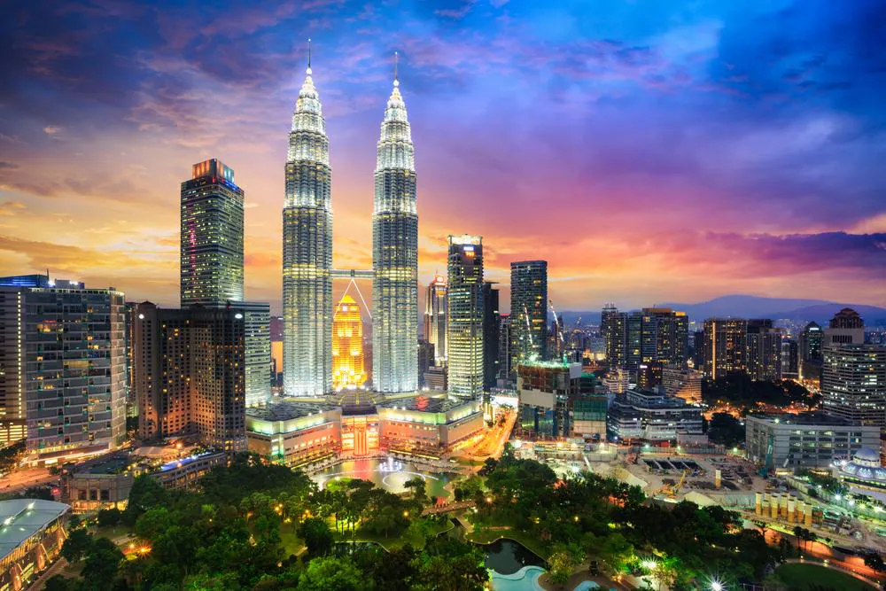 Malaysia travel overview showing city skyline islands and rainforest regions