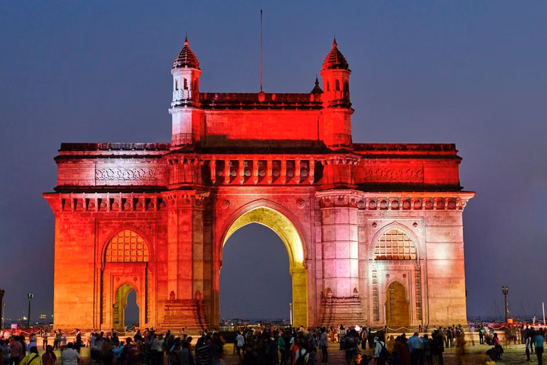 Gateway of India illuminated in evening with crowd in Mumbai
